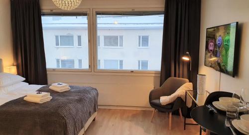 a hotel room with a bed and a window at Myplace in Oulu Studio Koulukatu in Oulu