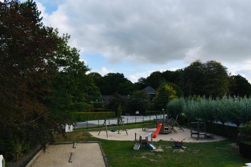 a park with a playground with play equipment in it at Barbos in Lembeke