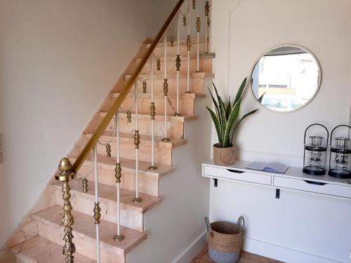 a staircase in a home with a round mirror at Maison de Marcel Big house near centre free parking in Bruges