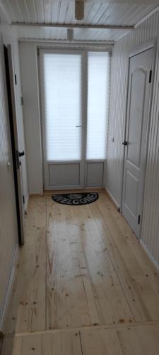 an empty room with a window and a wooden floor at Villa Opir in Skole