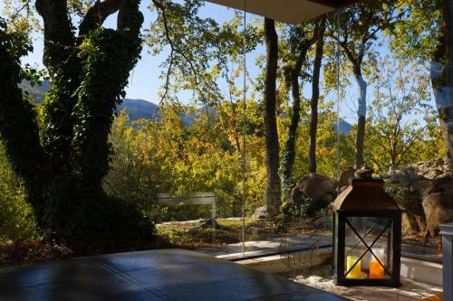 a lantern sitting on a table with a view of trees at Isolated Villa Terna -Big Garden-Pool-Dalmatia in Slime
