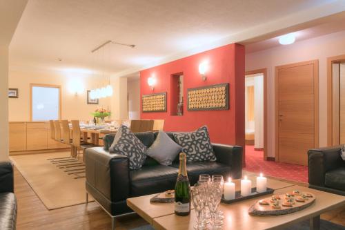 a living room with a couch and a table with candles at Chalet Gamskar in Sankt Anton am Arlberg