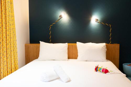 a bed with two pillows and a toy on it at ibis Styles Nancy Centre Gare in Nancy