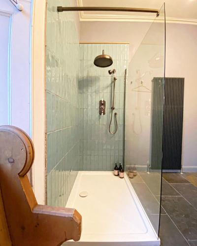 a bathroom with a shower with a glass door at Ben A'an House in Callander
