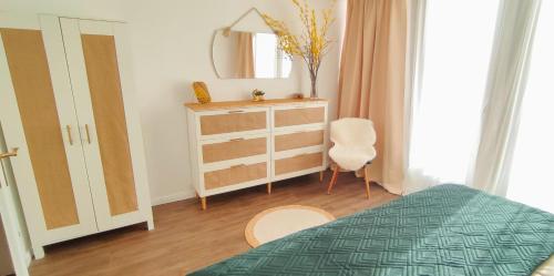a bedroom with a bed and a dresser and a mirror at Stilvolle Galeriewohnung im Land der tausend Berge in Marsberg