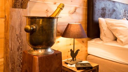 a champagne bottle in a bucket on a table next to a bed at Superior Suite Bergparadies Sauna - barrierfree in Inzell