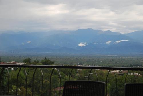 a view of a mountain range from a balcony at Shanshe in Gurjaani