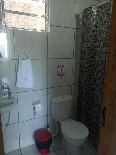 a bathroom with a toilet and a shower and a sink at Casa do Mochileiro Airport Hostel & Pousada in São Gonçalo do Amarante