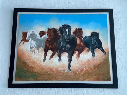 a painting of horses running in a field at Hotel Manhattan Barbosa in Barbosa