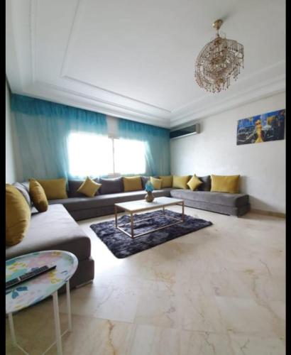 a living room with a couch and a table at Résidence jnane California in Casablanca