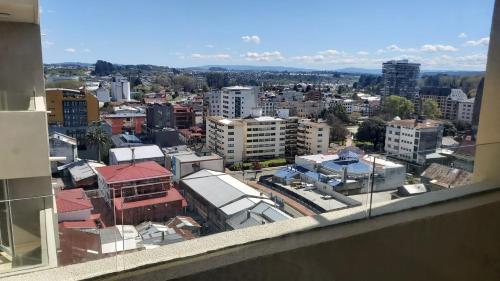 a view of a city from a window at Departamento Centro Osorno in Osorno