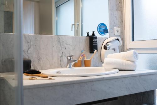 a bathroom counter with a sink and a mirror at ibis Styles Nancy Centre Gare in Nancy