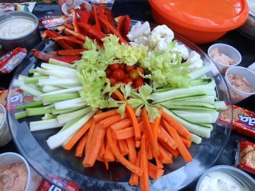 a plate with carrots celery and other vegetables on a table at Green Corner in Cahuita