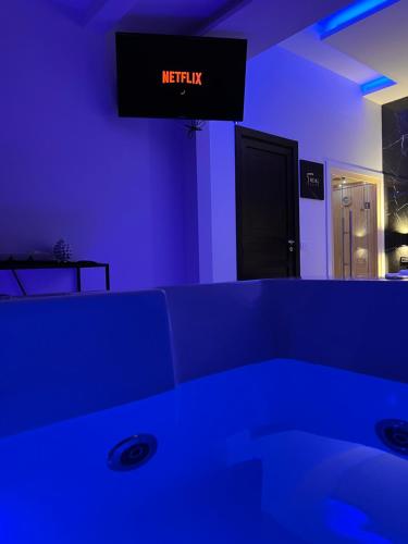 a blue room with a bed and a sign that reads methuana at Real suite spa in Palermo