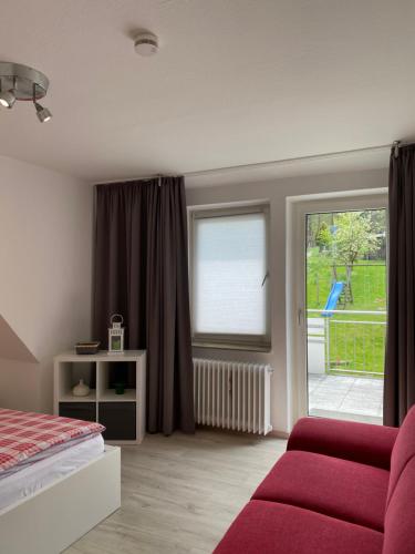 a bedroom with a bed and a sliding glass door at Ferienhof Kröger in Bielefeld