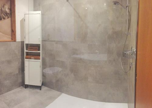 a bathroom with a shower with a glass door at At the Potter’s House in Niederndorf