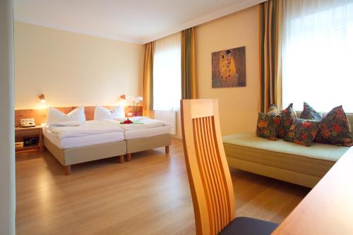 a hotel room with two beds and a window at Hotel & Restaurant Ragginger Attersee in Nussdorf am Attersee