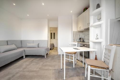 a living room with a couch and a table at Anius Apartments in Mýkonos City