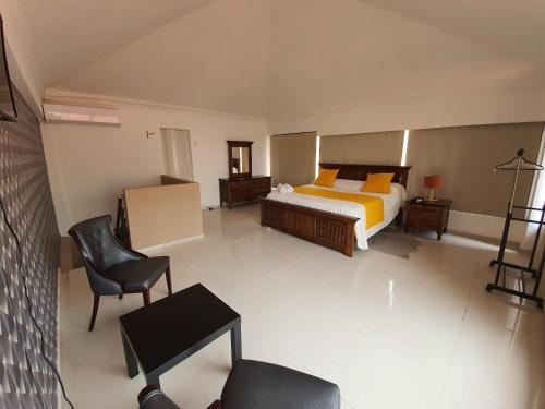 Postel nebo postele na pokoji v ubytování Malecon Rooms y Hotel