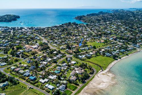 an aerial view of a suburb next to the ocean at Bach 14 - Stay Waiheke in Blackpool