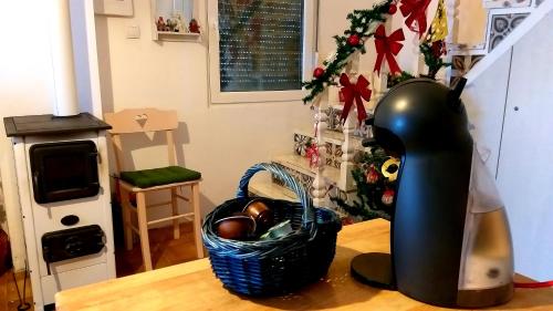 a table with a vase on a table with a christmas tree at Honey hill apartment Fruska Gora in Čerević