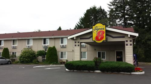 a fast food restaurant with a sucker sign in a parking lot at Super 8 by Wyndham Shelton in Shelton