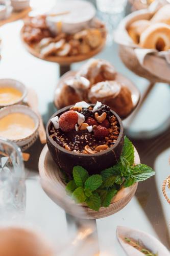 a chocolate dessert on a plate with other pastries at Naatooh Guest Houses in Florianópolis