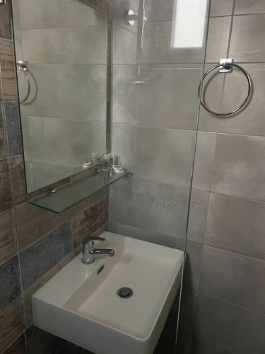 a bathroom with a sink and a mirror at Vrahos in Kardamaina