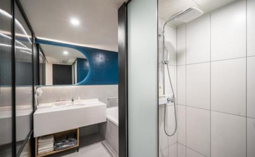 a bathroom with a sink and a shower at HOTEL701 Masan in Changwon