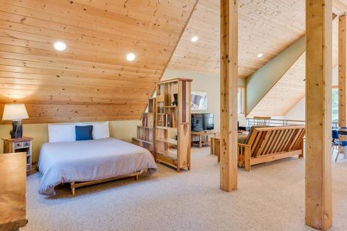 a bedroom with a bed and a wooden ceiling at Hot Tub Cool Views: Roaring Creek Cabin in Leavenworth