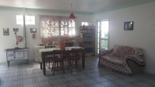 a living room with a table and a couch at Solar da Lagoa in Florianópolis