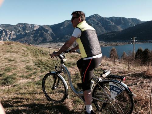 a man is riding a bike on a hill at Hotel Liberty in Levico Terme