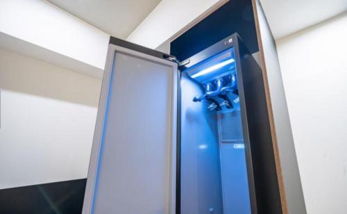 a blue shower in a room with a mirror at HOTEL701 Masan in Changwon