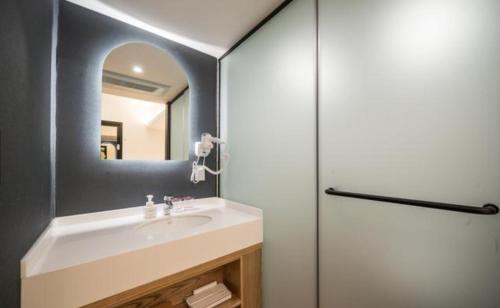 a bathroom with a sink and a mirror at HOTEL701 Masan in Changwon