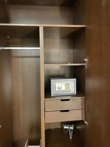 a small cabinet with a radio in it at HOTEL LES ARCADES in Abomey-Calavi