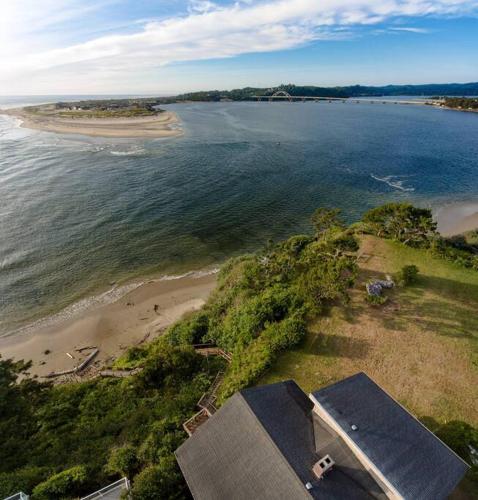 an aerial view of a beach and the ocean at Panoramic Promontory: Bay View Beach House in Waldport