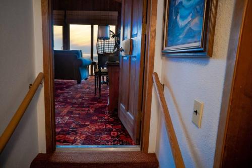 a hallway with a door leading to a living room at Panoramic Promontory: Bay View Beach House in Waldport