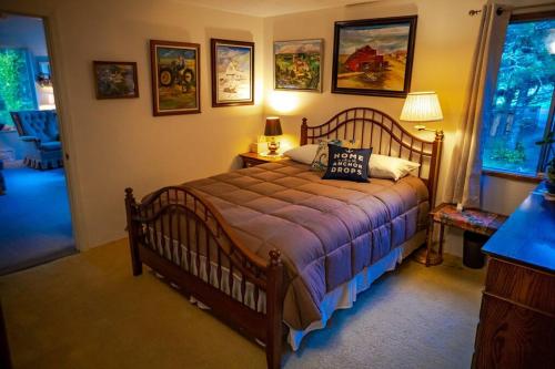 a bedroom with a wooden bed with pillows on it at Panoramic Promontory: Bay View Beach House in Waldport
