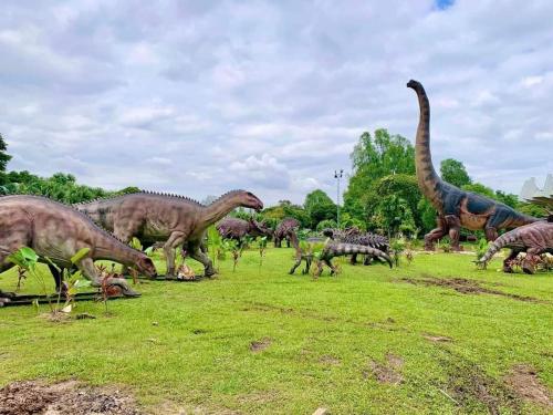 a group of dinosaurs eating grass in a field at TC Maya Abaya Hotel in Kuantan