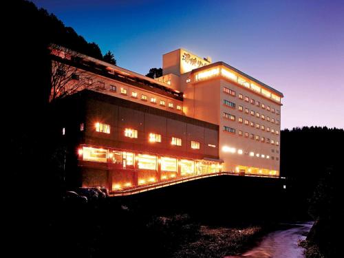 a building with lights in front of it at night at Yukai Resort Premium Miyoshiya in Shinonsen