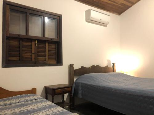 Ένα ή περισσότερα κρεβάτια σε δωμάτιο στο Casa de praia em Paúba perto de cachoeira e 5min de Maresias