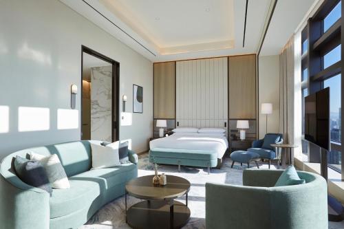 a hotel room with a bed and two chairs at Grand InterContinental Seoul Parnas by IHG in Seoul