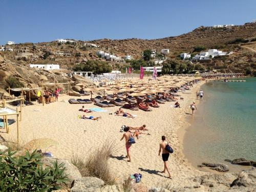 a group of people on a beach near the water at Artemis Studio Pyrgi in Mýkonos City