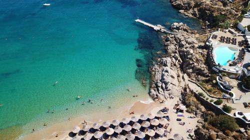 an aerial view of a beach with people in the water at Artemis Studio Pyrgi in Mýkonos City