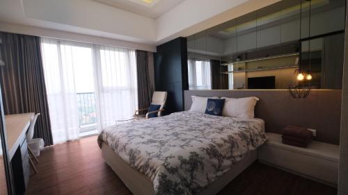 a bedroom with a bed and a large window at Bella Casa, Apt Casa de Parco closed to AEON and ICE BSD in Samporo