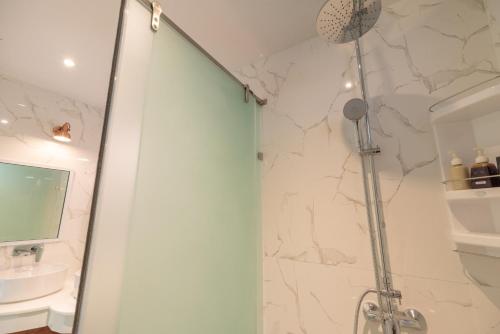 a bathroom with a shower and a sink at Wandee Garden in Choeng Mon Beach