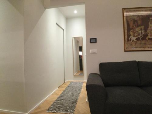 a living room with a couch and a hallway at Suite Florio in Turin