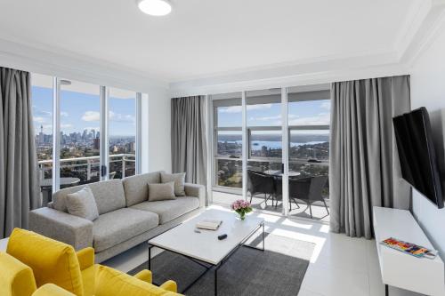 a living room with a couch and a table at Meriton Suites Bondi Junction in Sydney