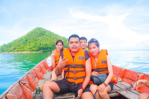 a group of people sitting in a boat on the water at Lazy Bones in Koh Rong Sanloem