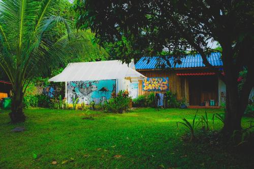 a house with graffiti on the side of it at Lazy Bones in Koh Rong Sanloem